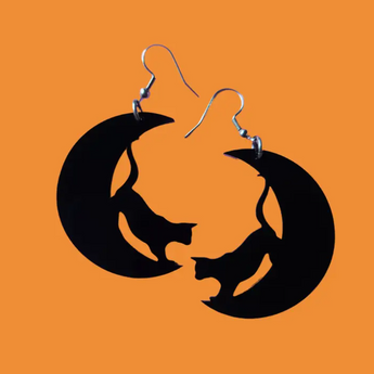 Black acrylic earrings featuring a sleek cat silhouette poised to leap off a crescent moon.
