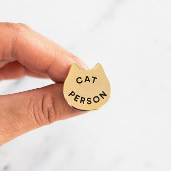 Cat Person Enamel Pin - Gold-plated pin featuring a cat face with 'Cat Person' engraving, a tribute to feline affection.