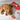 Orange cat lying on a wooden floor with various cat toys around it.