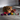Cat playing with colorful toys on a wooden floor