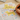 Yellow cat-shaped stickers with text on a piece of paper with a hand holding a pen.