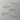 Set of gold paper clips shaped like cats on a white background