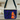 Colorful bag with a cat and floral design on a black background