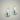 Gold earrings featuring a white sitting cat with delicate flower accents – whimsical cat jewelry for women