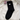 Black sock with a white cat design on a white sweater