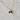 Gold Cat Necklace with Black and White Cat Pendant displayed on white fabric