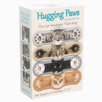  A box of Hugging Paws Bandages featuring bandages shaped like four different cat breeds: an orange tabby, a grey tabby, a black cat, and an American shorthair.