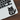 Sticker of a cat with text on a laptop keyboard