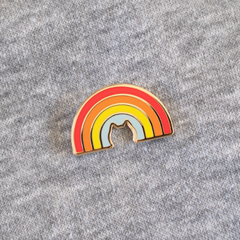 Over The Rainbow Cat Enamel Pin - Gold-plated pin with rainbow colors and cat silhouette.