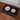 Black mat with white cat illustrations on a wooden floor