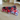 Two plaid bow tie collars side by side: one in red/navy, the other in red/white/blue