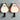 Two cat-shaped night lights, one gray and one red, on a white background.