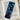Glossy laminated bookmark with a black cat and swirling golden stars on a deep blue background.