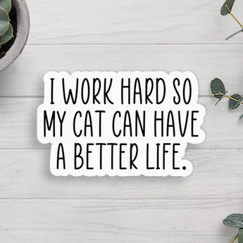 A white sticker with black text that reads "I Work Hard So My Cat Can Have A Better Life."