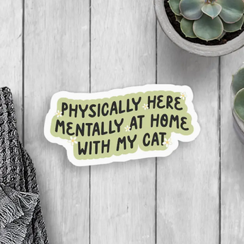 A white and matte green sticker with black text that reads "Physically Here Mentally at Home With My Cat," embellished with white daisies.