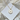 Gold necklace with paw print pendant on a white card with 'Carmel Sky' branding, against a soft floral background.
