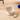 Cat-shaped toy with a mouse on a wooden surface
