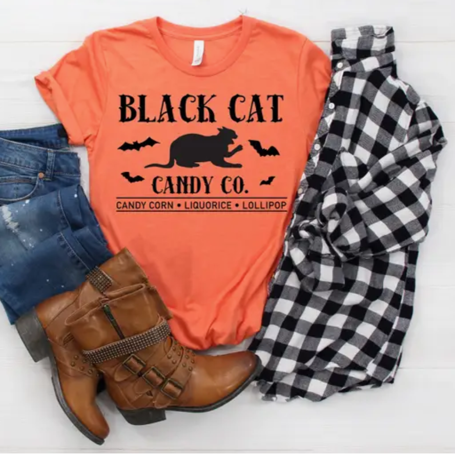 Black Cat Halloween shirt Featuring A Black cat Silhouette And The Words "Black Cat Candy Co" On an Orange Cotton Fabric
