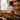 Woman holding a tote bag with book design in a library setting