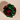 Red and green crumpled foil ball on a beige background