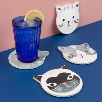 Close-up of cat face coaster in use