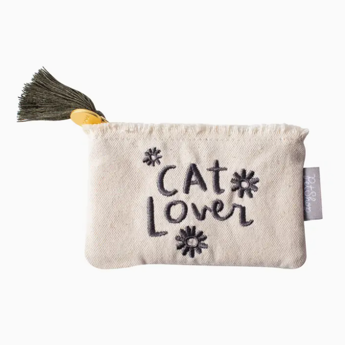 Cat Lover Pouch made of natural canvas with embroidered black flowers and 'Cat Lover' text, featuring fringed edges, zipper closure, and a grey tassel, measuring 5” x 3.25”, a stylish accessory for cat enthusiasts.