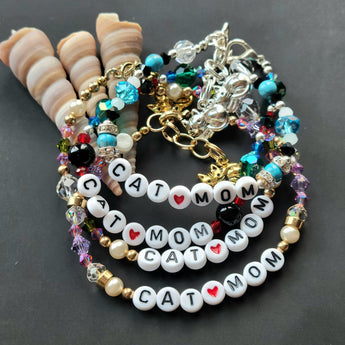 Collection of handmade Cat Mom Bracelets featuring various bead designs and cat charms.