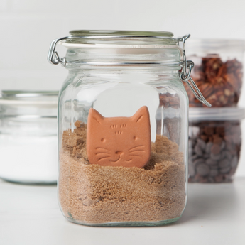 Cat-shaped Terracotta Sugar Saver being gently soaked in water to maintain sugar moisture