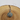 Silver pendant with a circular design on a wooden surface