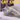 A gray cat with bright orange eyes lies on a lavender surface, with bold yellow text reading 'CAT CHAT' across the top and a humorous caption at the bottom. This appears to be a printed or digital cover-style product image rather than a plain product-on-white shot.