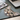 Cat-shaped mouse pad on a desk with a laptop, glasses, and book in the background