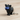 Black cat-shaped keychain with glowing eyes on a white background
