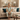 Woman in pajamas sitting on a couch in a cozy living room.