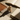 Wooden cat-shaped object on a surface with books and notebooks