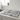 Kitchen counter with a placemat featuring cat illustrations, a mug, and glasses.