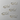 Set of gold paper clips shaped like cats on a white background