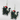 A pair of dangling earrings featuring cartoon black cats wearing red Santa hats and wrapped in multicolored Christmas lights, shown on a plain light background.