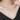 Necklace with a moon and star pendant worn by a person in a black top.