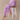 Woman sitting on a chair wearing women's cat print pajama pants.