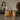 Glass jar with cat-shaped cookie and sand, next to a potted succulent on a kitchen counter.