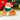 Orange tabby cat hair claw with Santa hat and green bandana, festive and fun holiday clip.