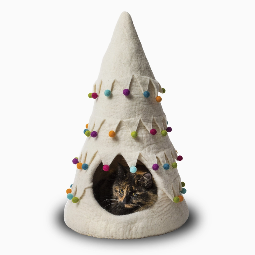 Feline curled up inside Christmas Tree Cat Bed, feeling cozy and festive