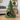Green felted pet bed shaped like a Christmas tree with colorful pom-poms, featuring a cat inside.