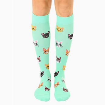 Close-up of Cat Compression Socks with smiling cat faces on neon green fabric.