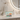 A mint green zippered pouch featuring a colorful illustration of an orange tabby cat sleeping on books next to a teacup with blue flowers. The pouch has a gold zipper and is shown on a clean white background.
