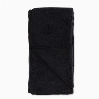 Set of 3 black Embroidered Paw Towels rolled up and stacked, highlighting their compact size and lightweight design.