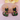 Black cat-shaped earrings with floral designs on a pink background