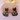 Black cat-shaped earrings with floral designs on a pink background