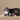 Cat lying on a beige surface with three cat toys around it.