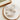 Gray scrunchie on a white plate with a wooden tray in the background